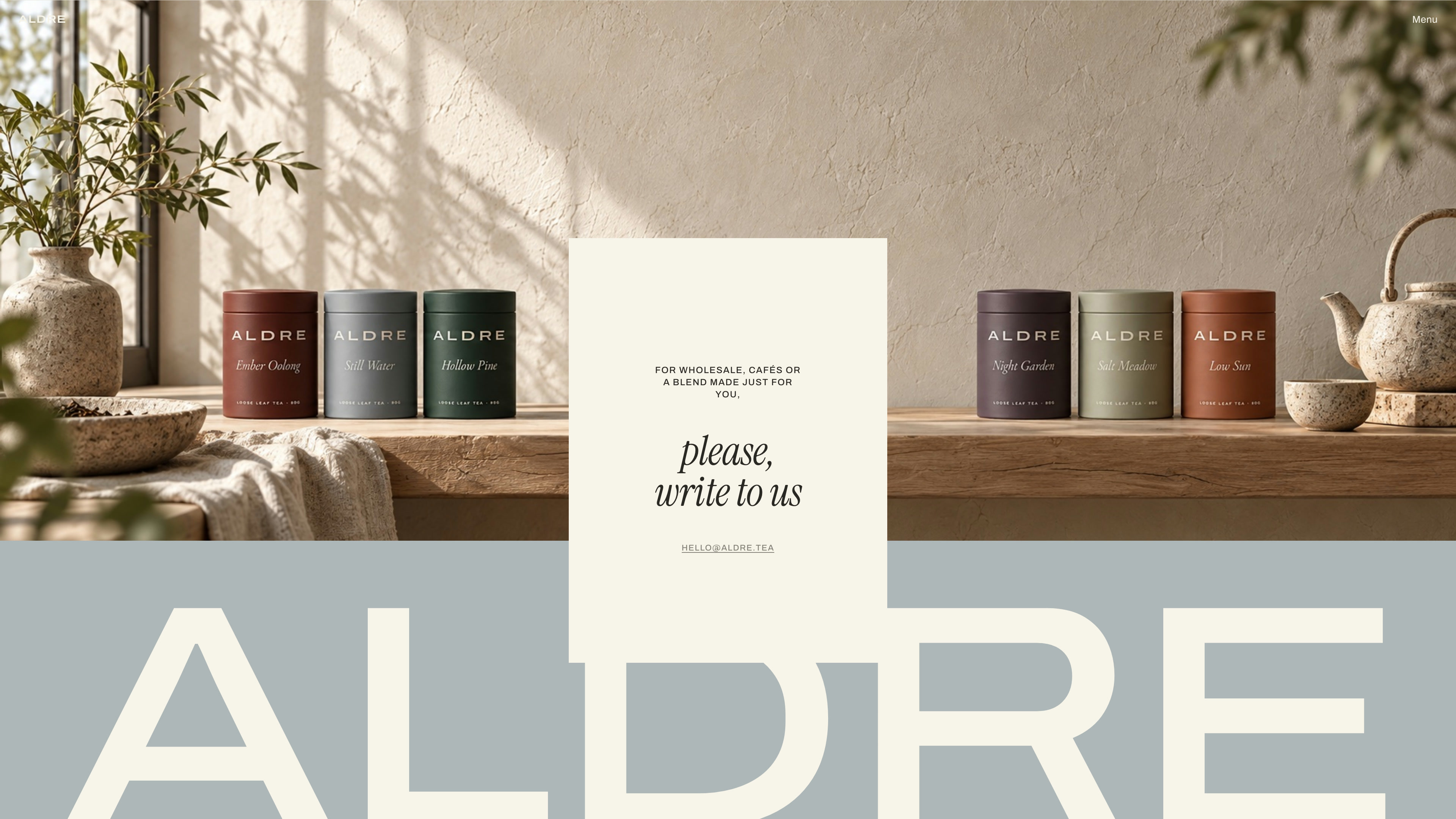 Contact: a cream card reading please, write to us over a tea counter and the ALDRE wordmark