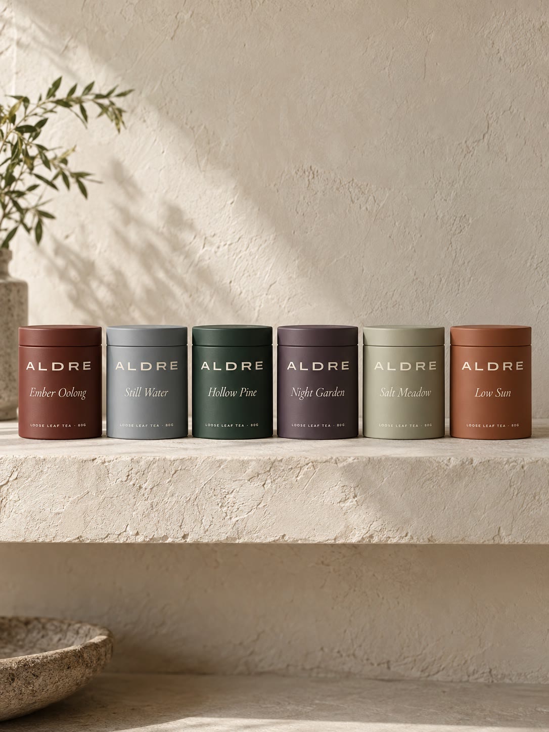 All six ALDRE tins in a row on a plaster shelf