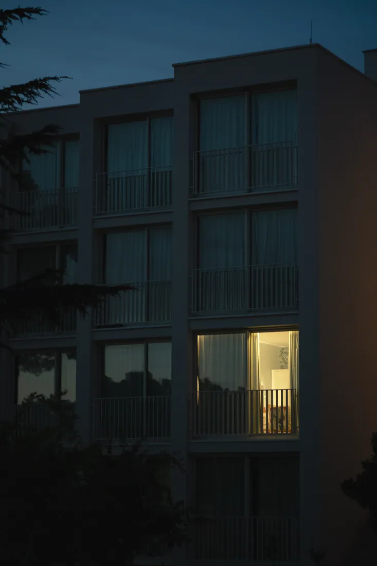 One window lit in a dark block