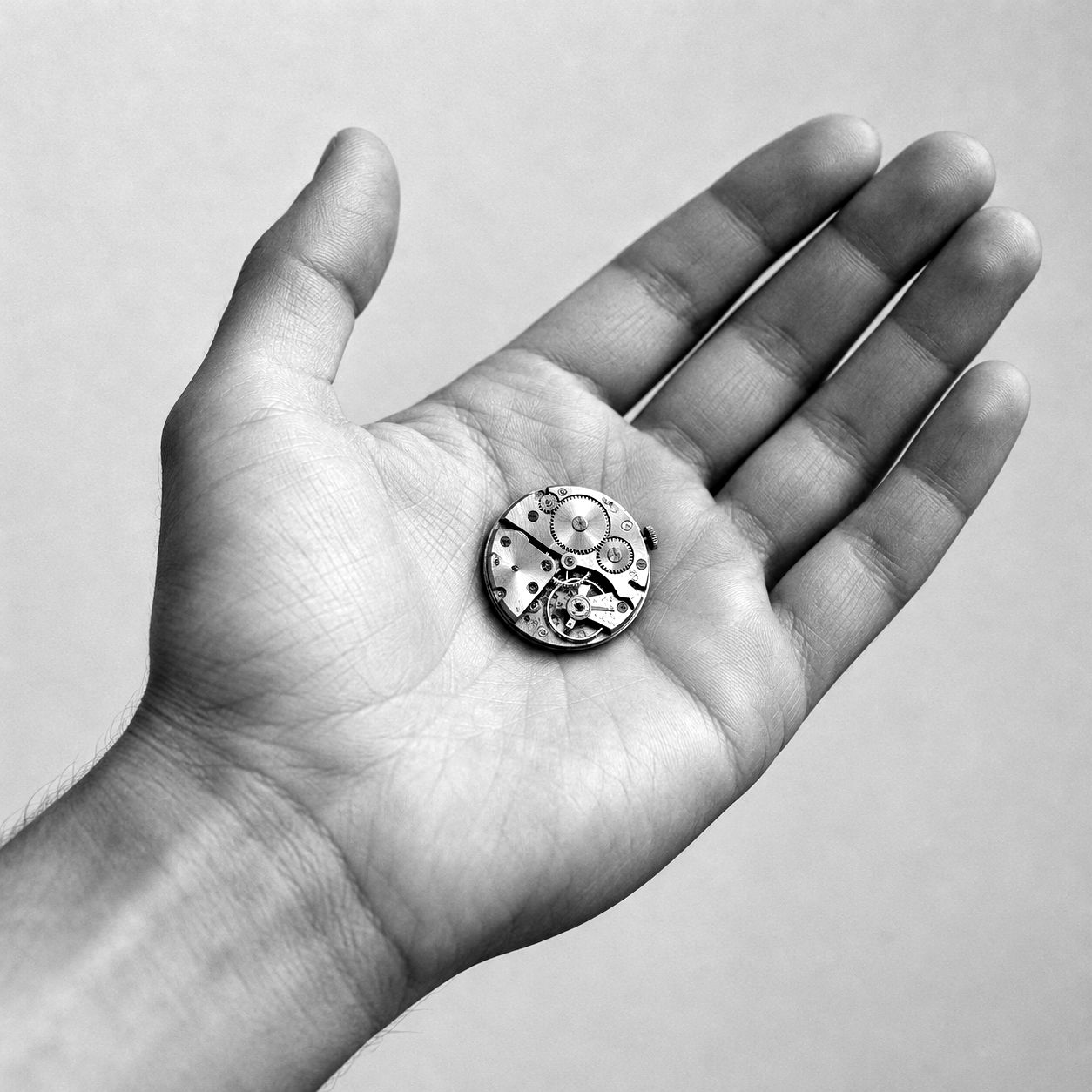 Open palm holding a small mechanical movement